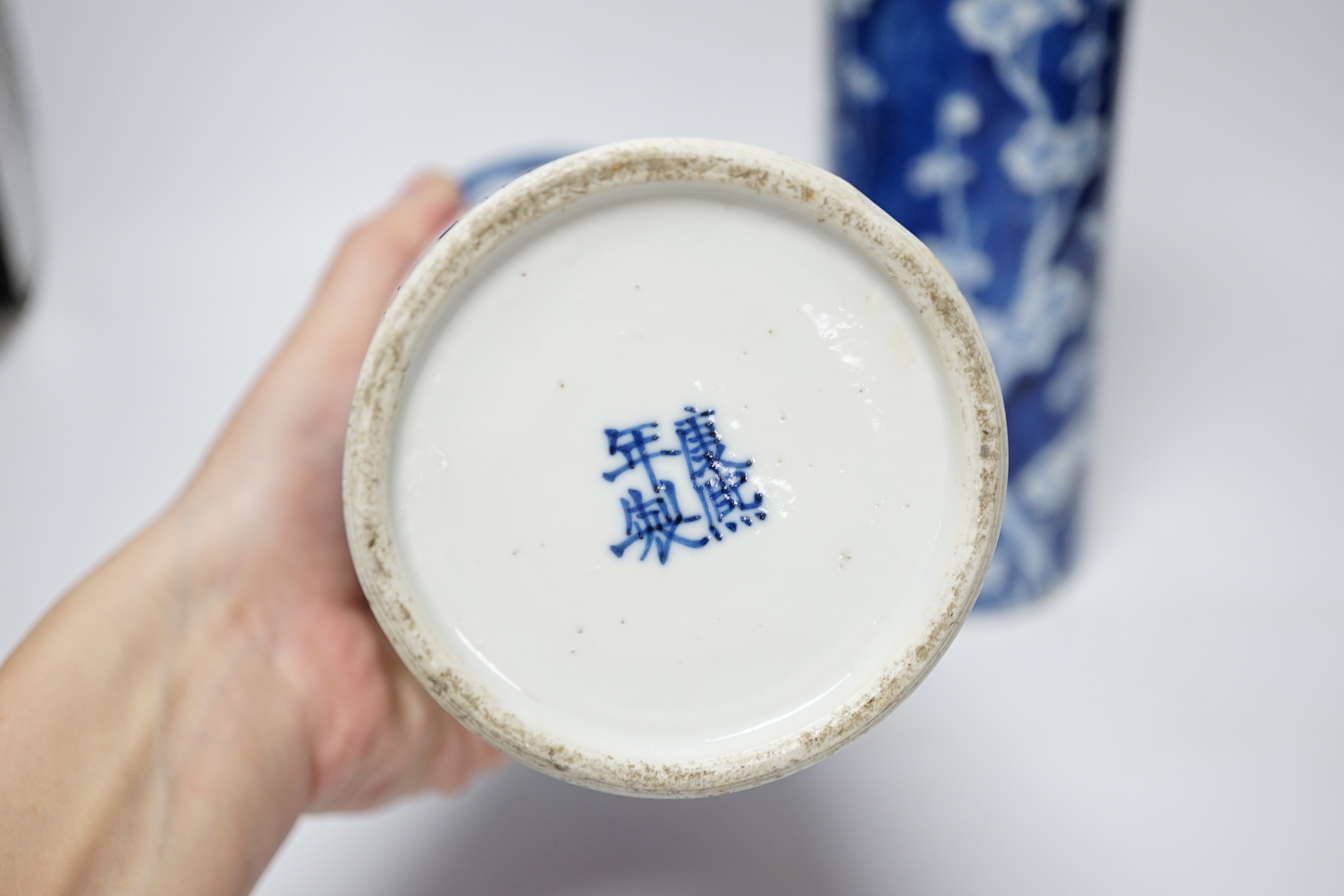 A pair of Chinese blue and white prunus flower sleeve vases, c.1900, (restored), 26cm high